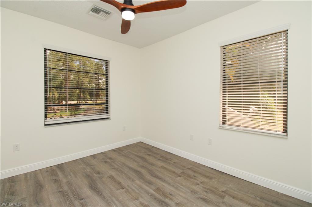 311 31st Street Northwest Naples, FL 34120 - Photo 39 of 50 a view of an empty room with wooden floor and a window