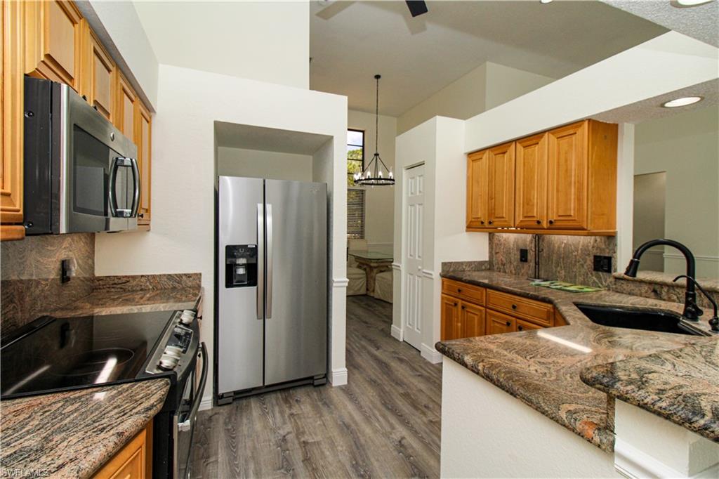 311 31st Street Northwest Naples, FL 34120 - Photo 4 of 50 a kitchen with stainless steel appliances granite countertop a sink stove and refrigerator