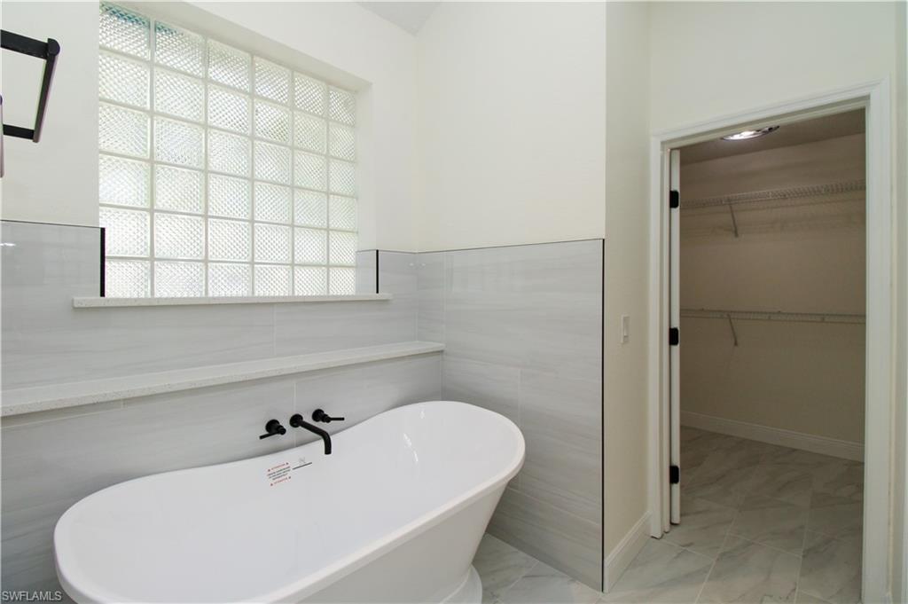 311 31st Street Northwest Naples, FL 34120 - Photo 50 of 50 a bathroom with a bathtub and shower