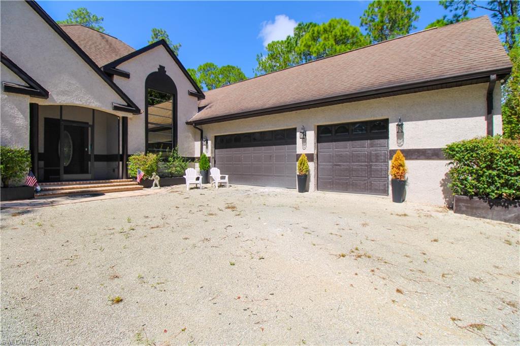 311 31st Street Northwest Naples, FL 34120 - Photo 10 of 50 a front view of a house with a yard