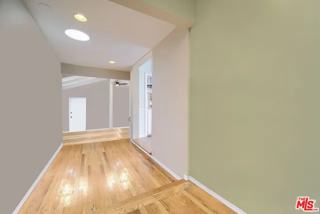 a view of hallway with wooden floor