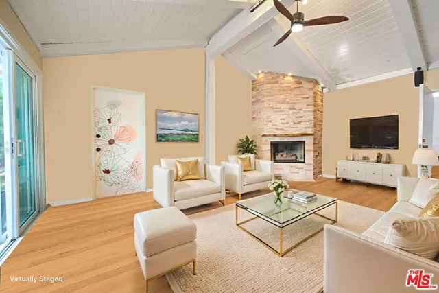 a living room with furniture fireplace and a flat screen tv
