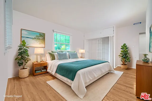 a bedroom with a bed and a potted plant