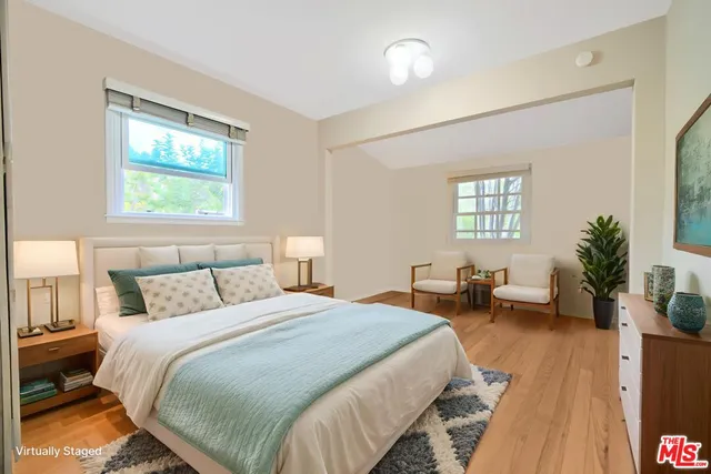 a bedroom with bed couch and window