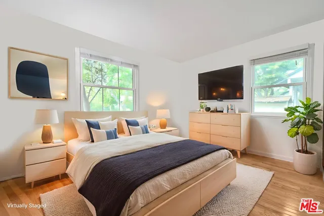 a bedroom with a bed and a flat screen tv