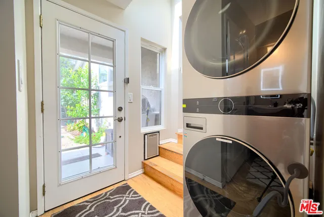 a living room with a fireplace and a large window