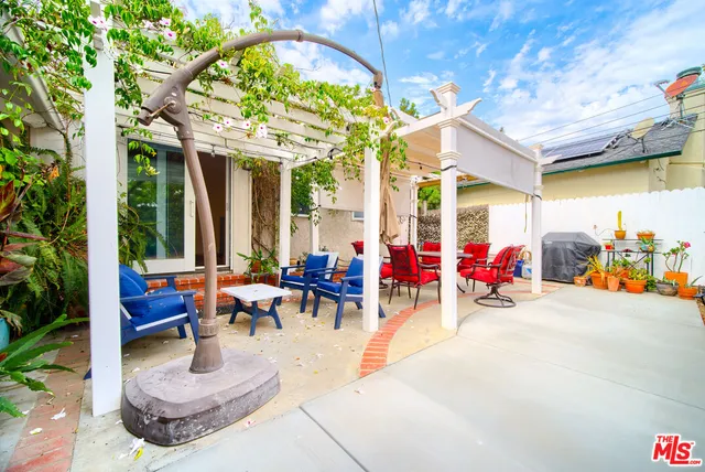 an outdoor space with patio furniture and potted plants