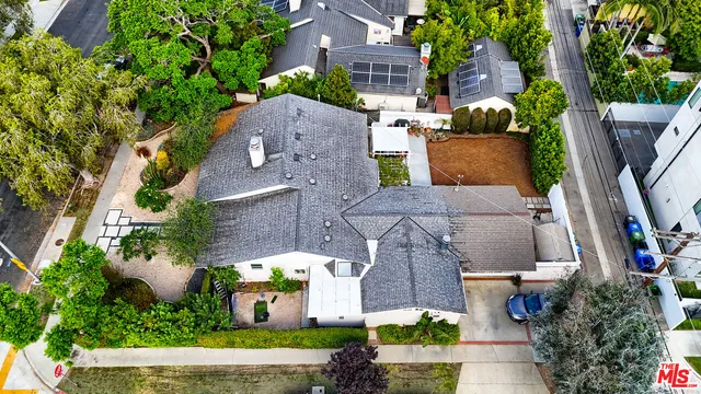 an aerial view of multiple houses with yard
