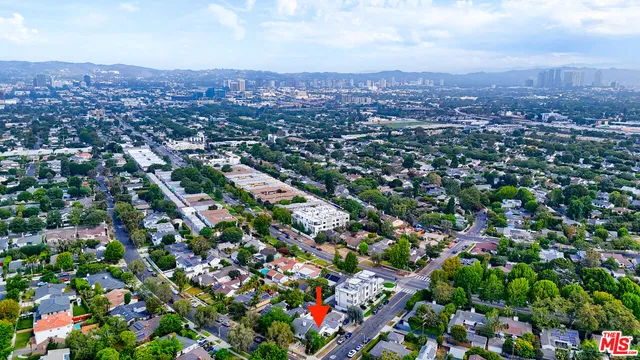 an aerial view of residential houses with city view