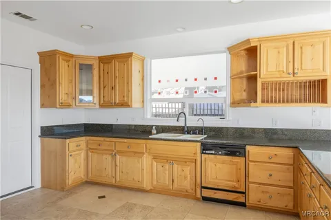 a kitchen with granite countertop a sink and dishwasher