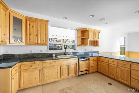 a kitchen with sink and cabinets