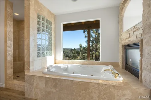a bathroom with bathtub and shower