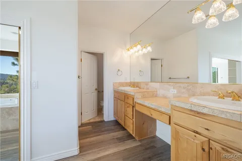 a spacious bathroom with a double vanity sink and a mirror