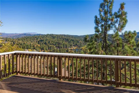 a balcony with wooden floor and fence
