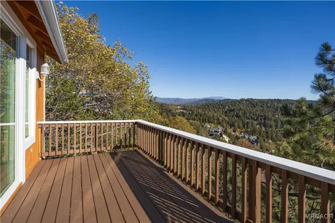 a view of balcony with wooden floor and fence