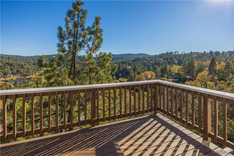 a view of balcony with wooden floor and fence