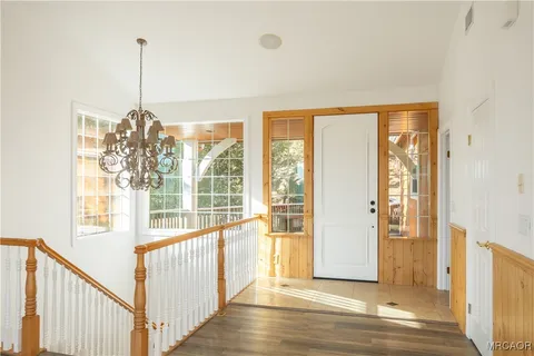a view of a room with wooden floor and windows
