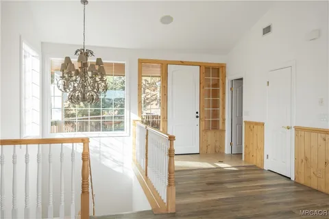 a view of a room with wooden floor and windows