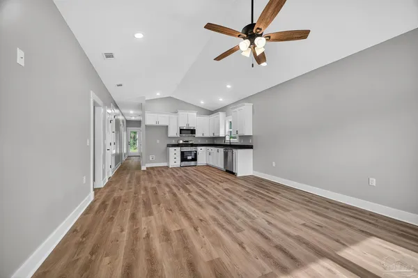 a view of kitchen with furniture and a ceiling fan