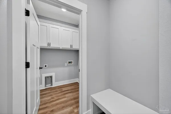 a view of a kitchen with white cabinets