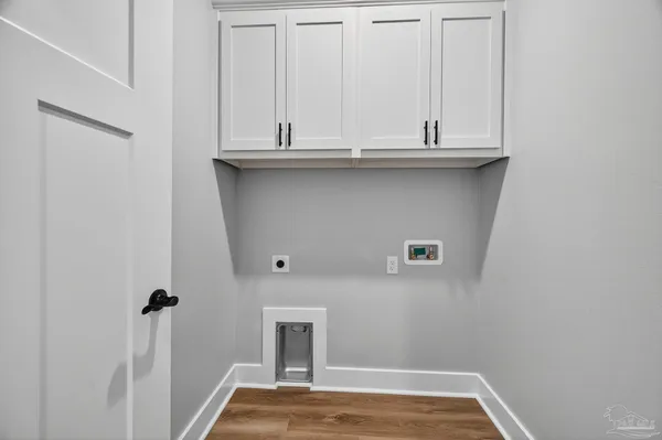 a view of a hallway with wooden floor and closet area