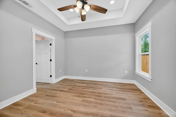 a view of closet with wooden floor
