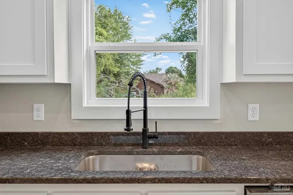 a kitchen with granite countertop a window
