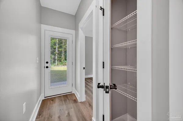 a view of an empty room with wooden floor