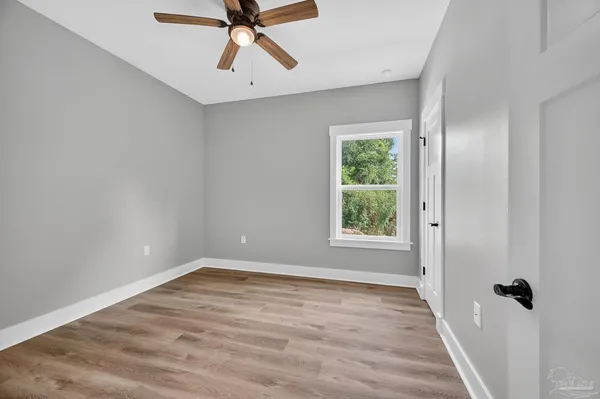 a view of a hallway with wooden floor