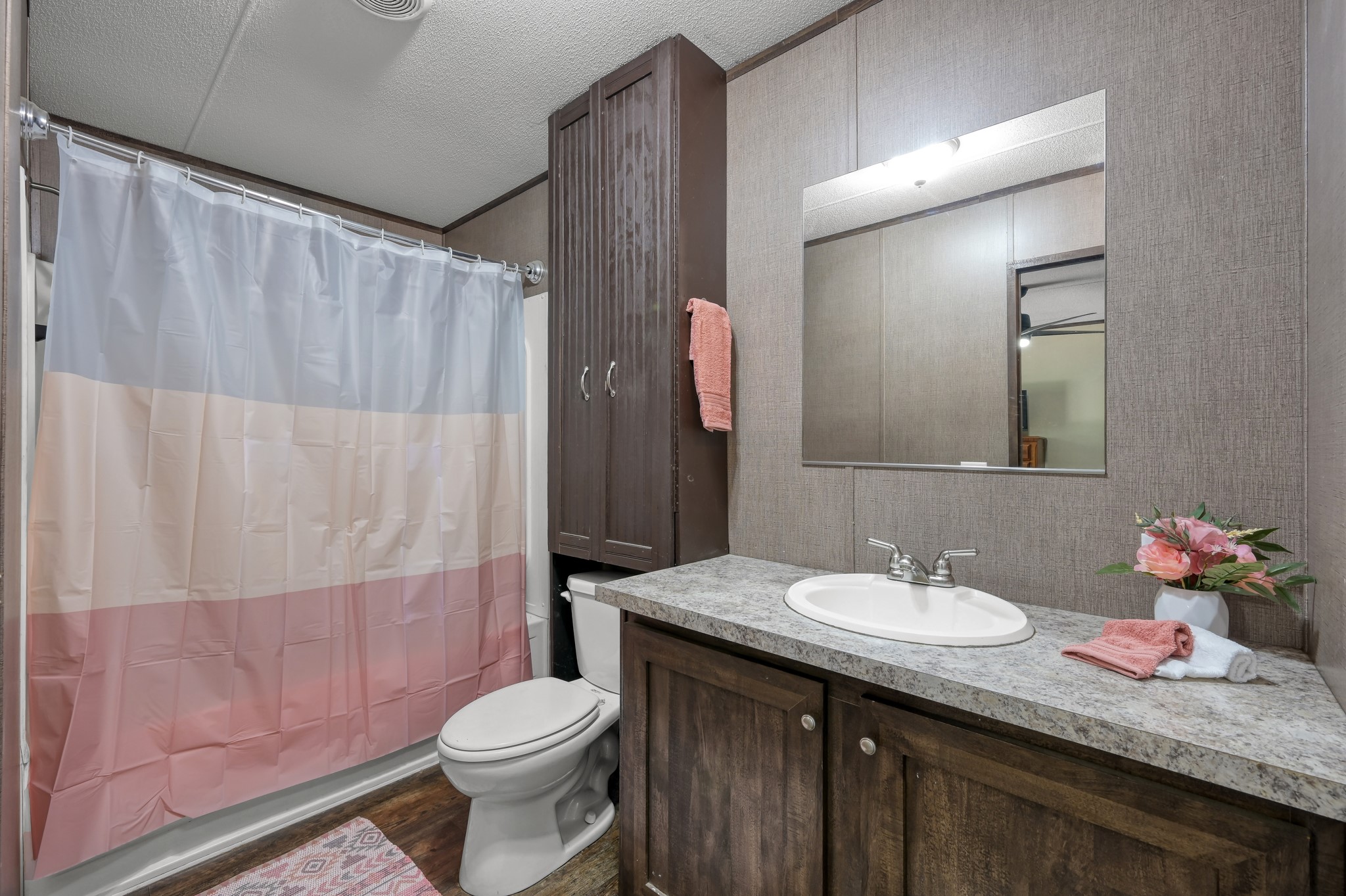 400 Raven Hill Road Oakhurst, TX 77359 - Photo 25 of 45 a bathroom with a sink a toilet and shower curtain