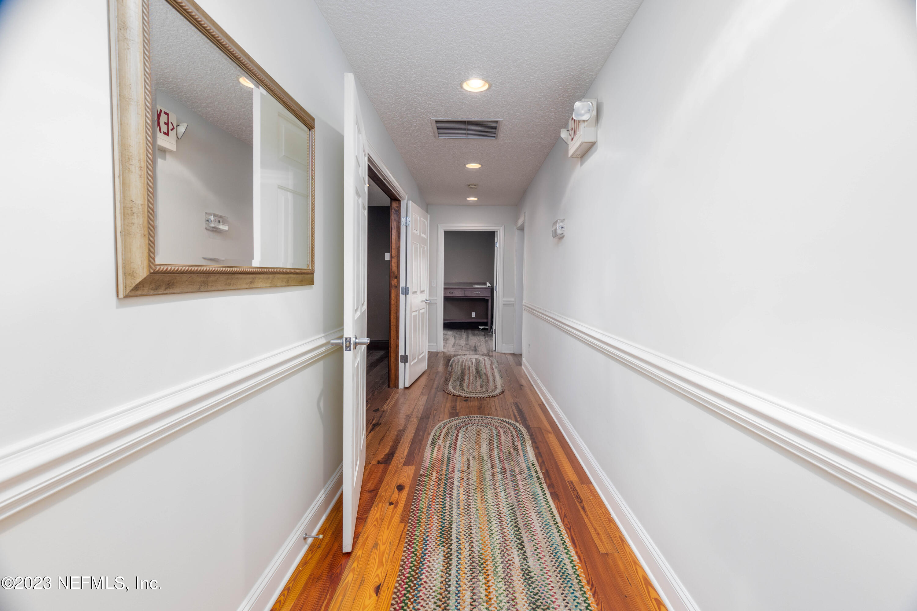 9636 Heckscher Drive Jacksonville, FL 32226 - Photo 27 of 43 a view of a hallway with wooden floor and staircase
