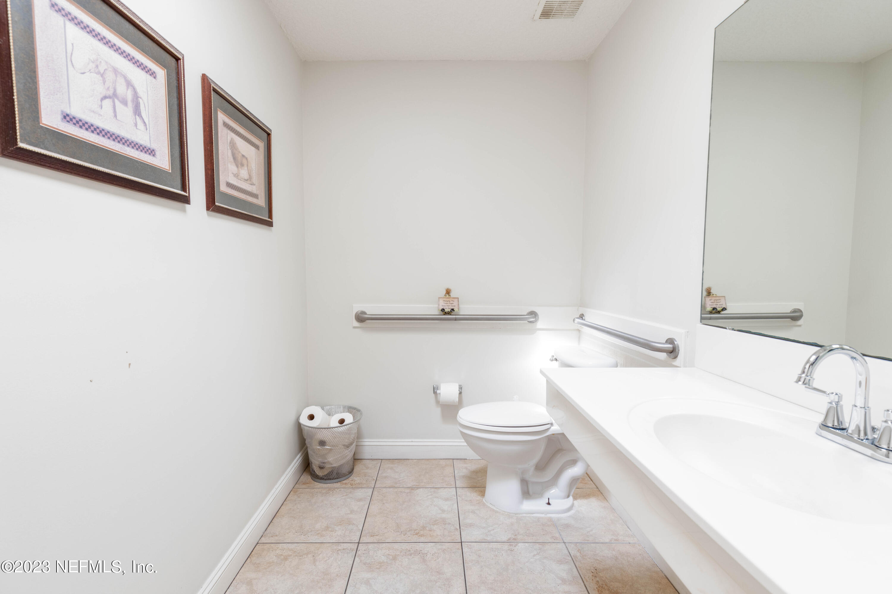 9636 Heckscher Drive Jacksonville, FL 32226 - Photo 37 of 43 a bathroom with a toilet a sink and mirror