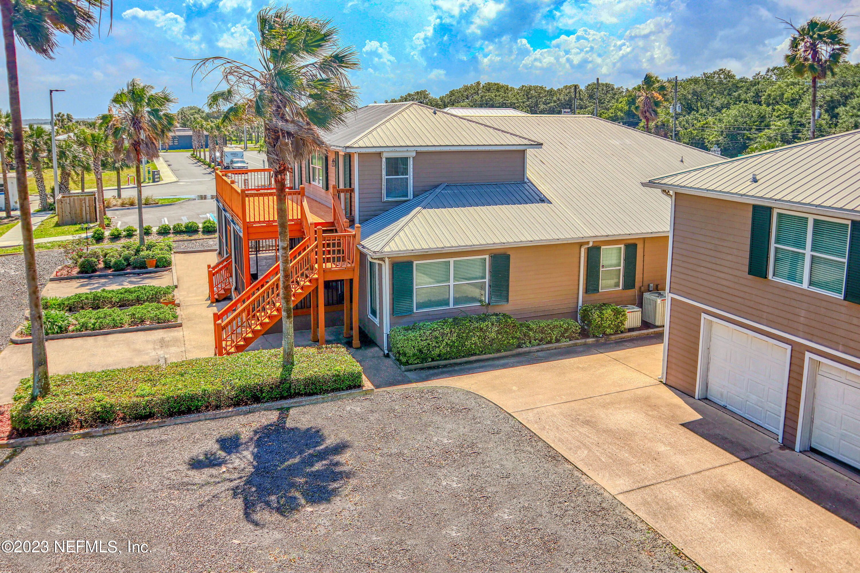 9636 Heckscher Drive Jacksonville, FL 32226 - Photo 8 of 43 a front view of a house with a yard and potted plants