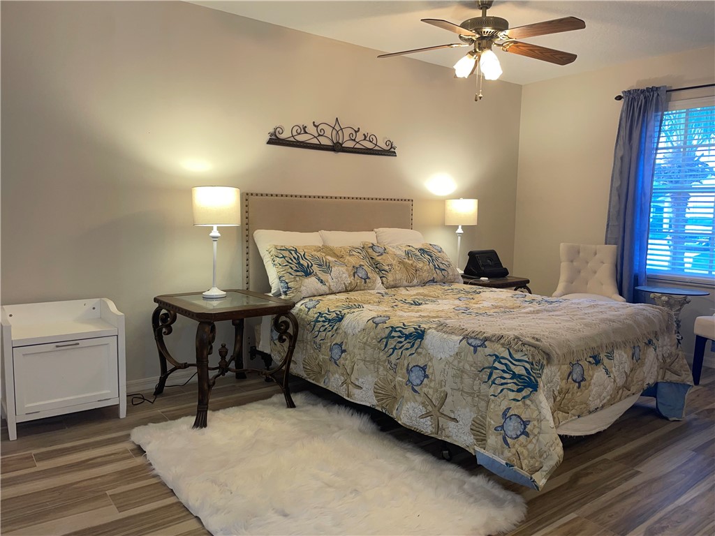 810 Southwest Commonwealth Road Port St. Lucie, FL 34953 - Photo 8 of 21 a bedroom with a bed and a chandelier
