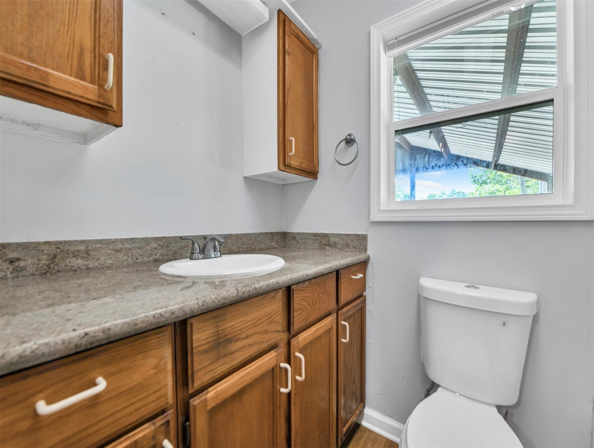 11304 Fostoria Road Cleveland, TX 77328 - Photo 12 of 32 a bathroom with a granite countertop sink and a toilet