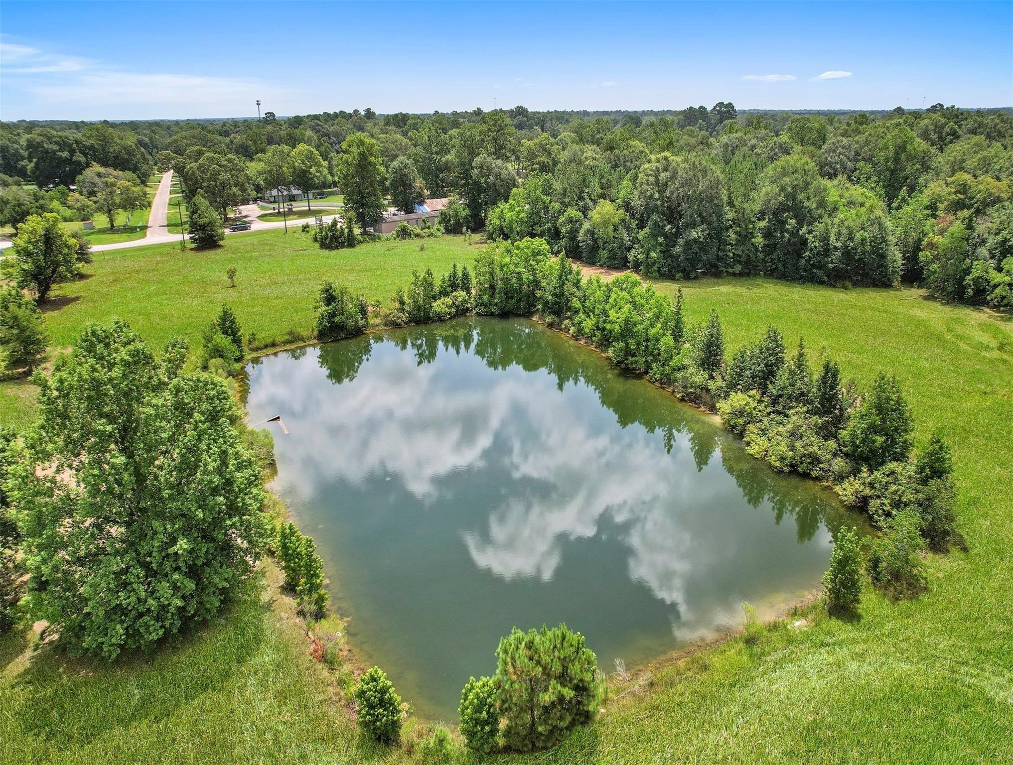 11304 Fostoria Road Cleveland, TX 77328 - Photo 23 of 32 a view of a lake with a yard