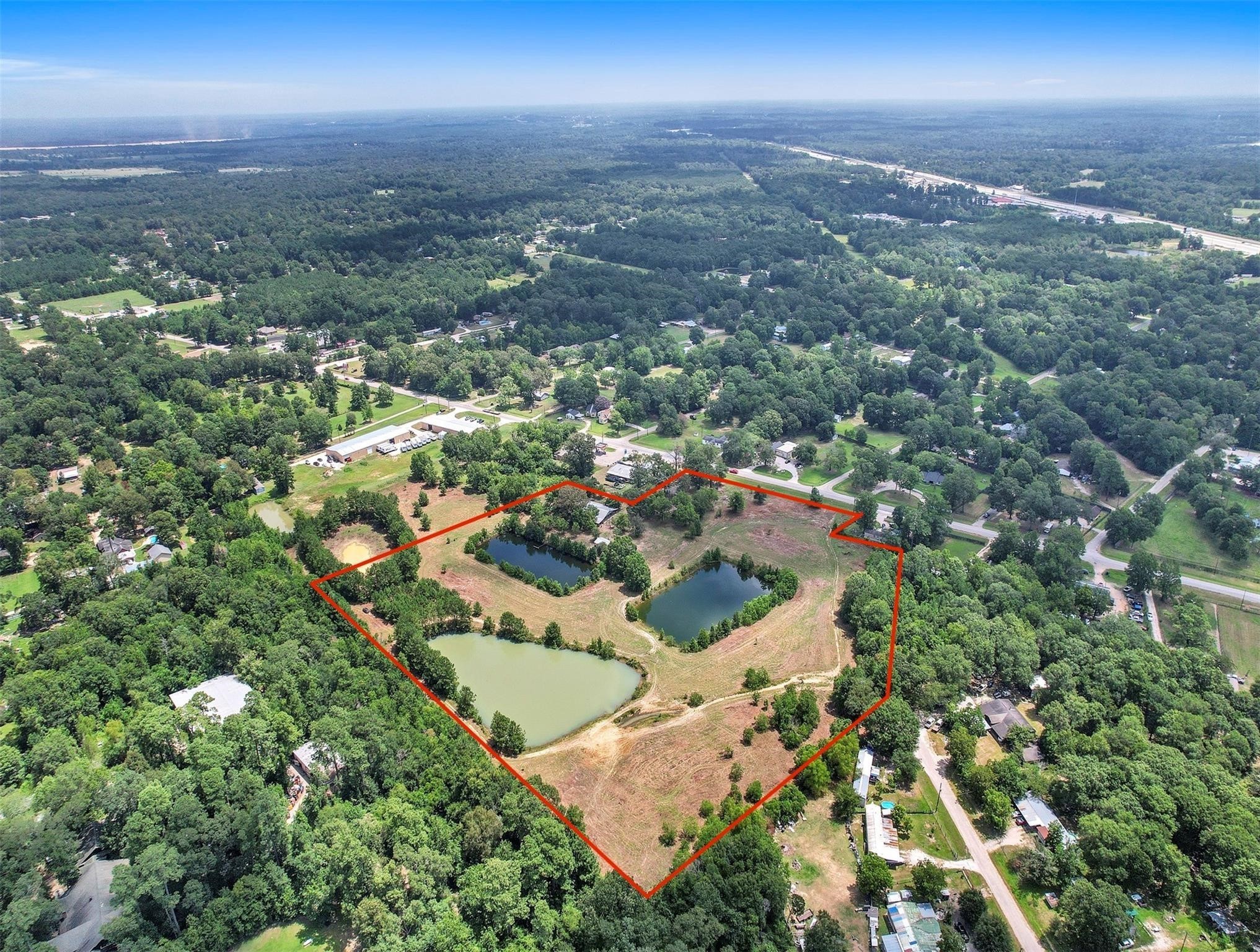 11304 Fostoria Road Cleveland, TX 77328 - Photo 26 of 32 an aerial view of residential houses with city and green space