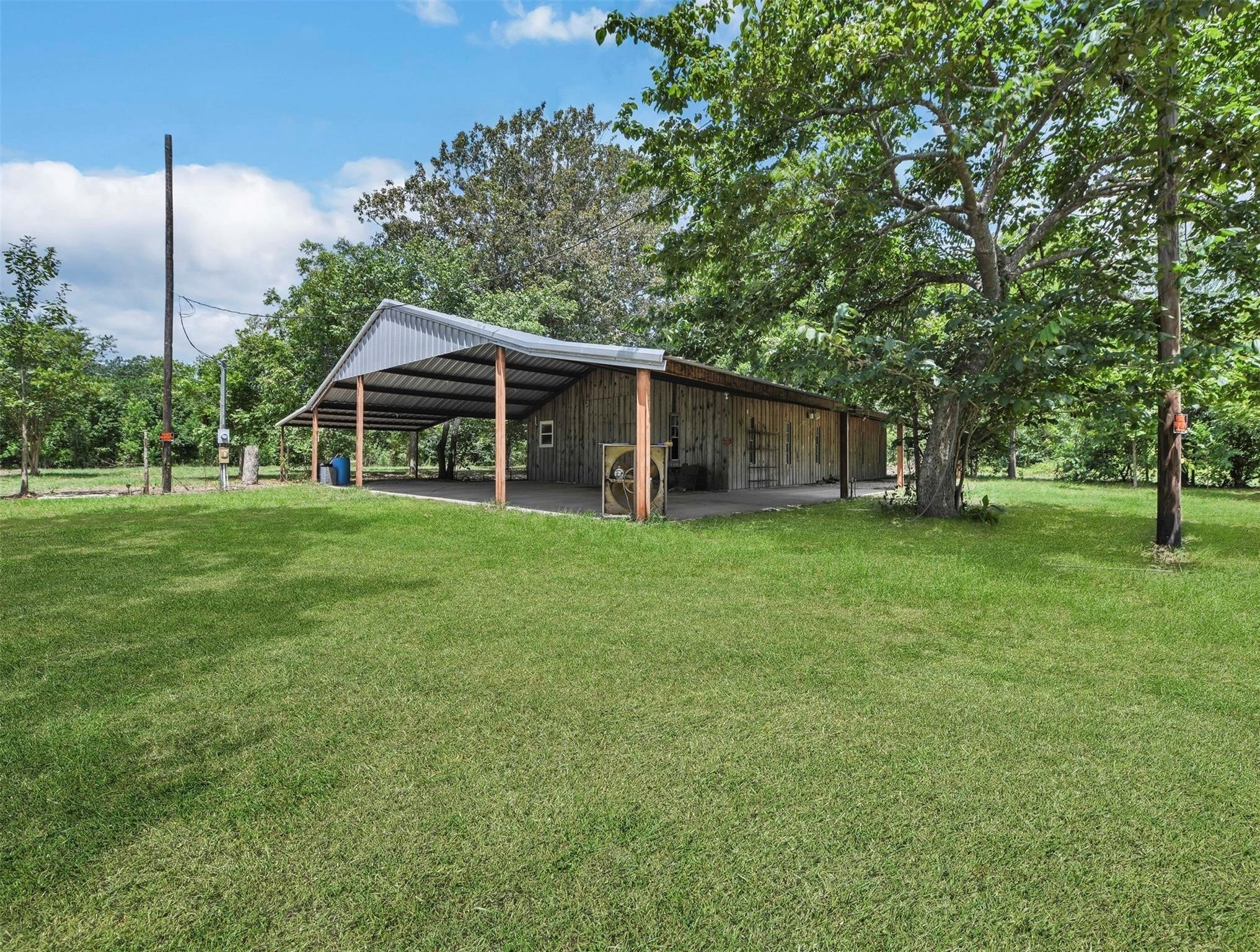 11304 Fostoria Road Cleveland, TX 77328 - Photo 30 of 32 a view of a house with a yard