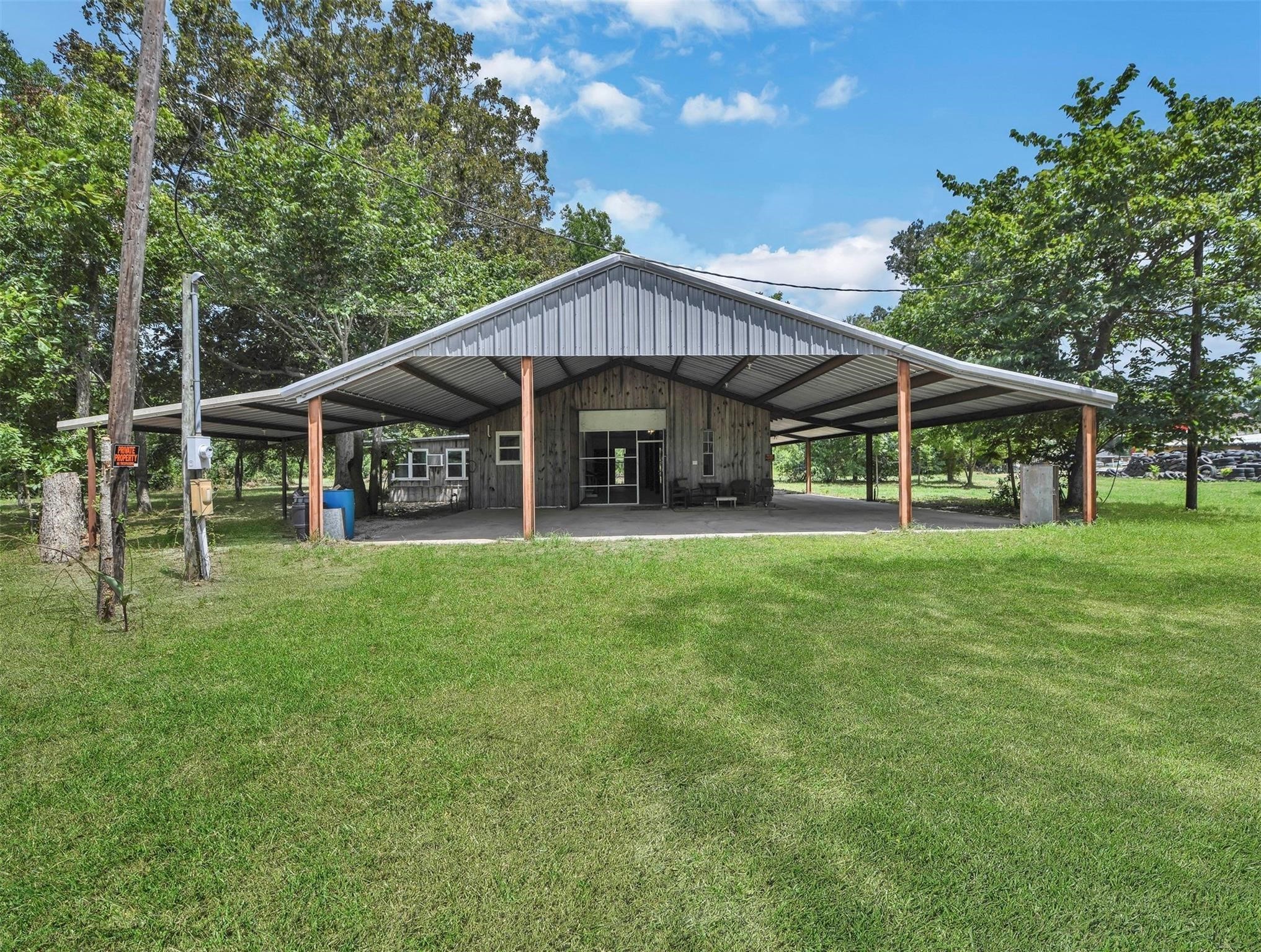 11304 Fostoria Road Cleveland, TX 77328 - Photo 5 of 32 a porch with a table and chairs under an umbrella