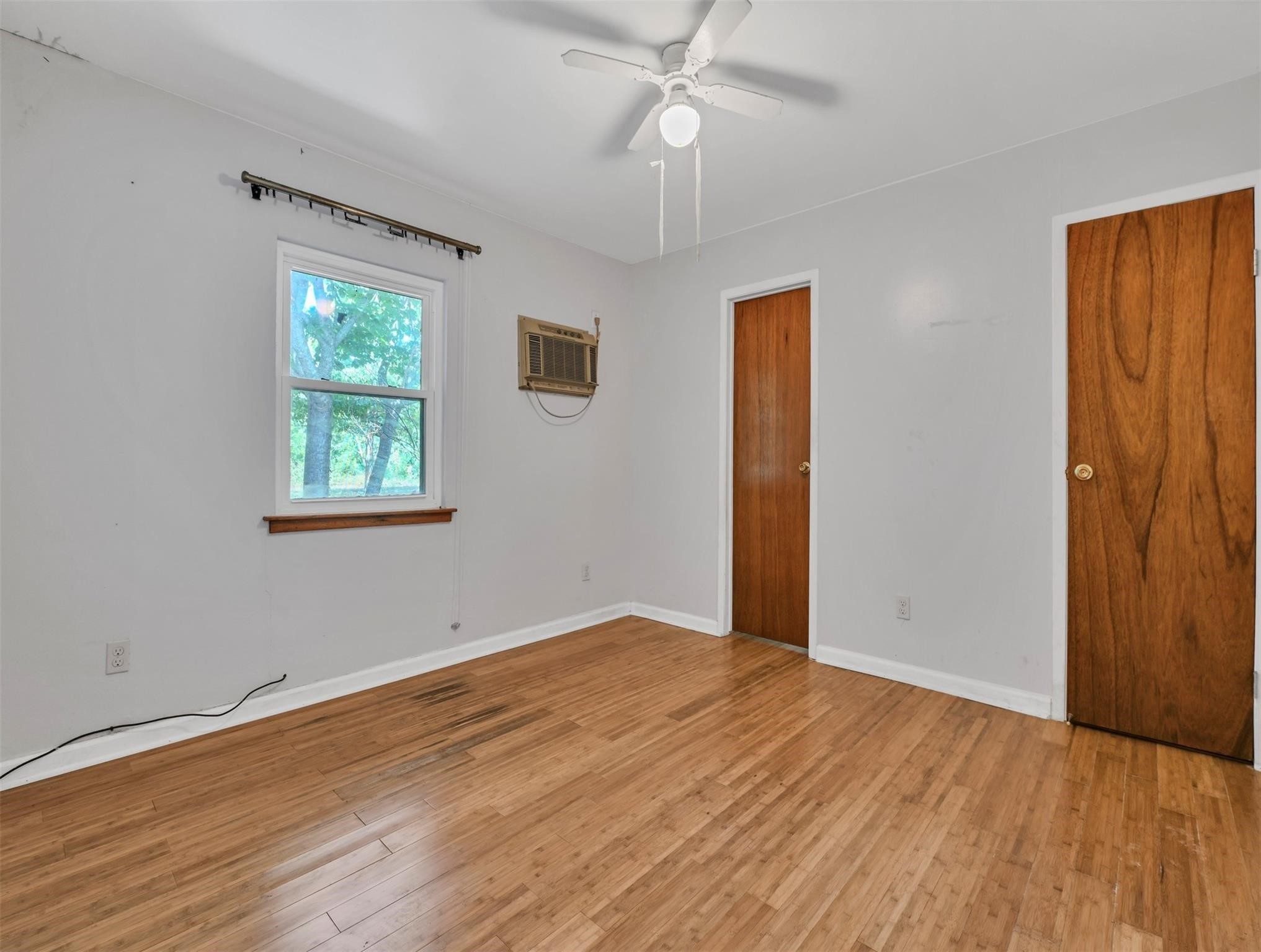 11304 Fostoria Road Cleveland, TX 77328 - Photo 10 of 32 an empty room with wooden floor closet and windows