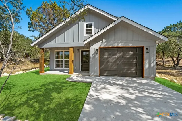 a front view of a house with a yard and porch