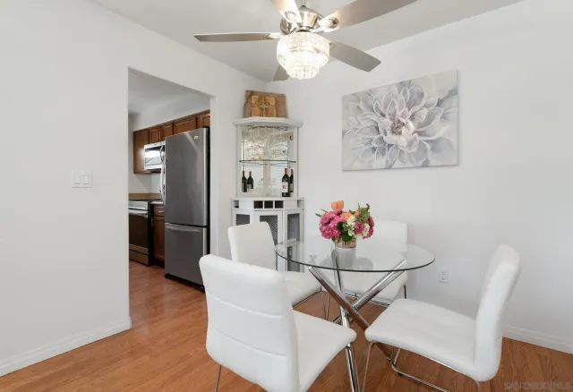 a view of a dining room with furniture and wooden floor