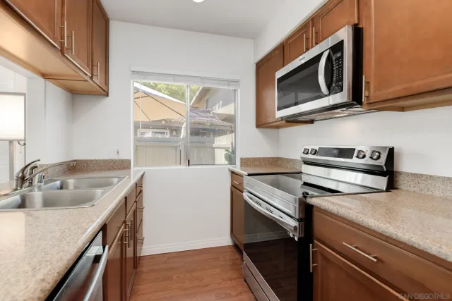 a kitchen with a stove microwave and sink