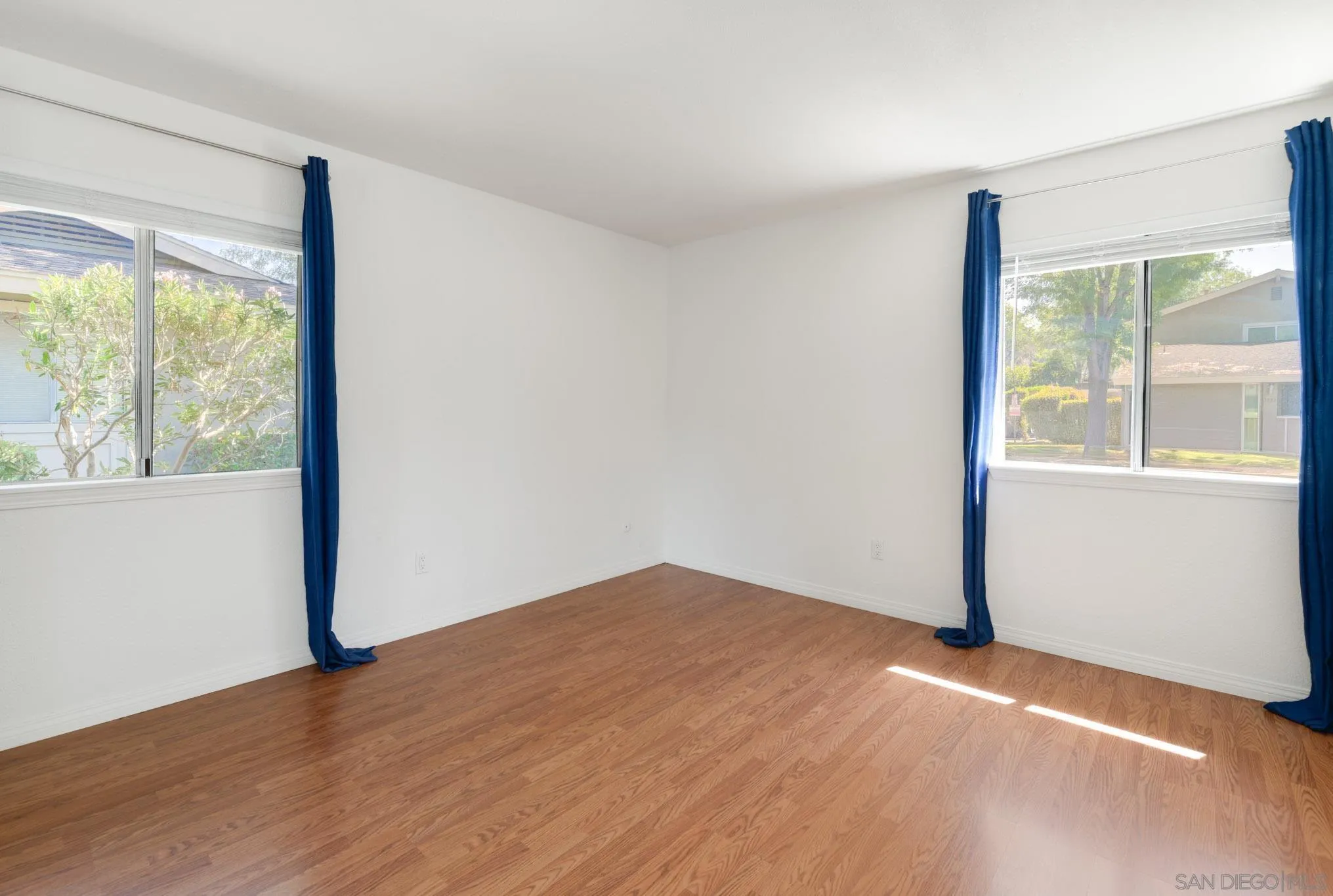 1536 Gustavo Street, Unit A El Cajon, CA 92019 - Photo 15 of 28 an empty room with wooden floor and windows