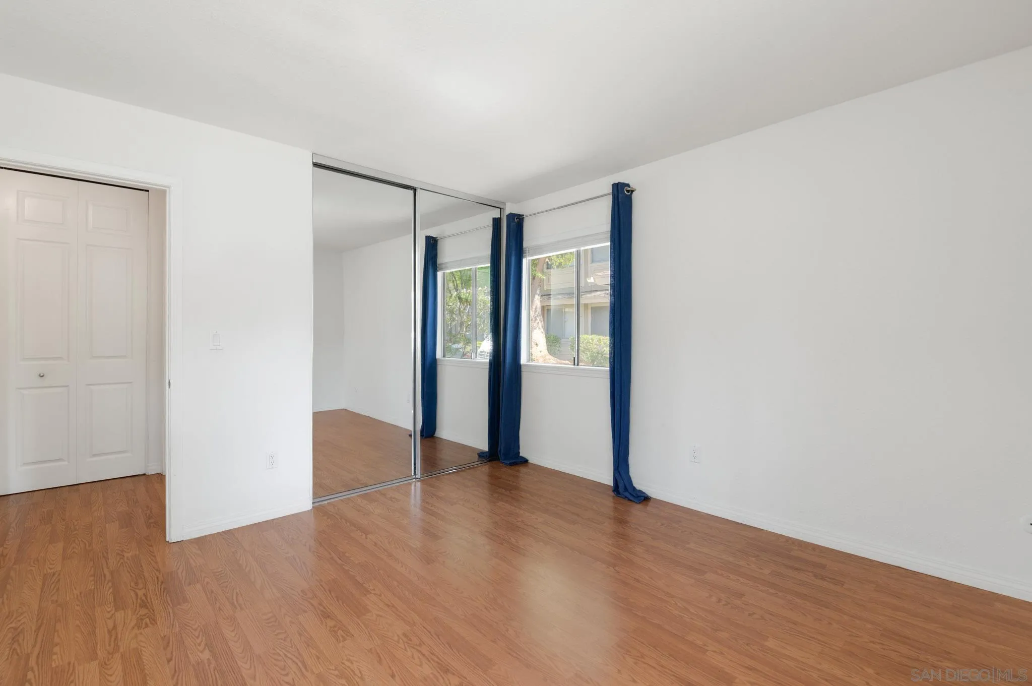 1536 Gustavo Street, Unit A El Cajon, CA 92019 - Photo 16 of 28 a view of an empty room with wooden floor and a window