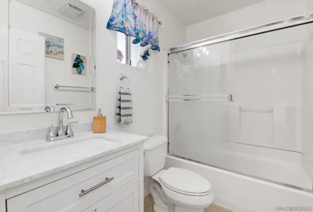 a bath room with a toilet a sink and a bath tub