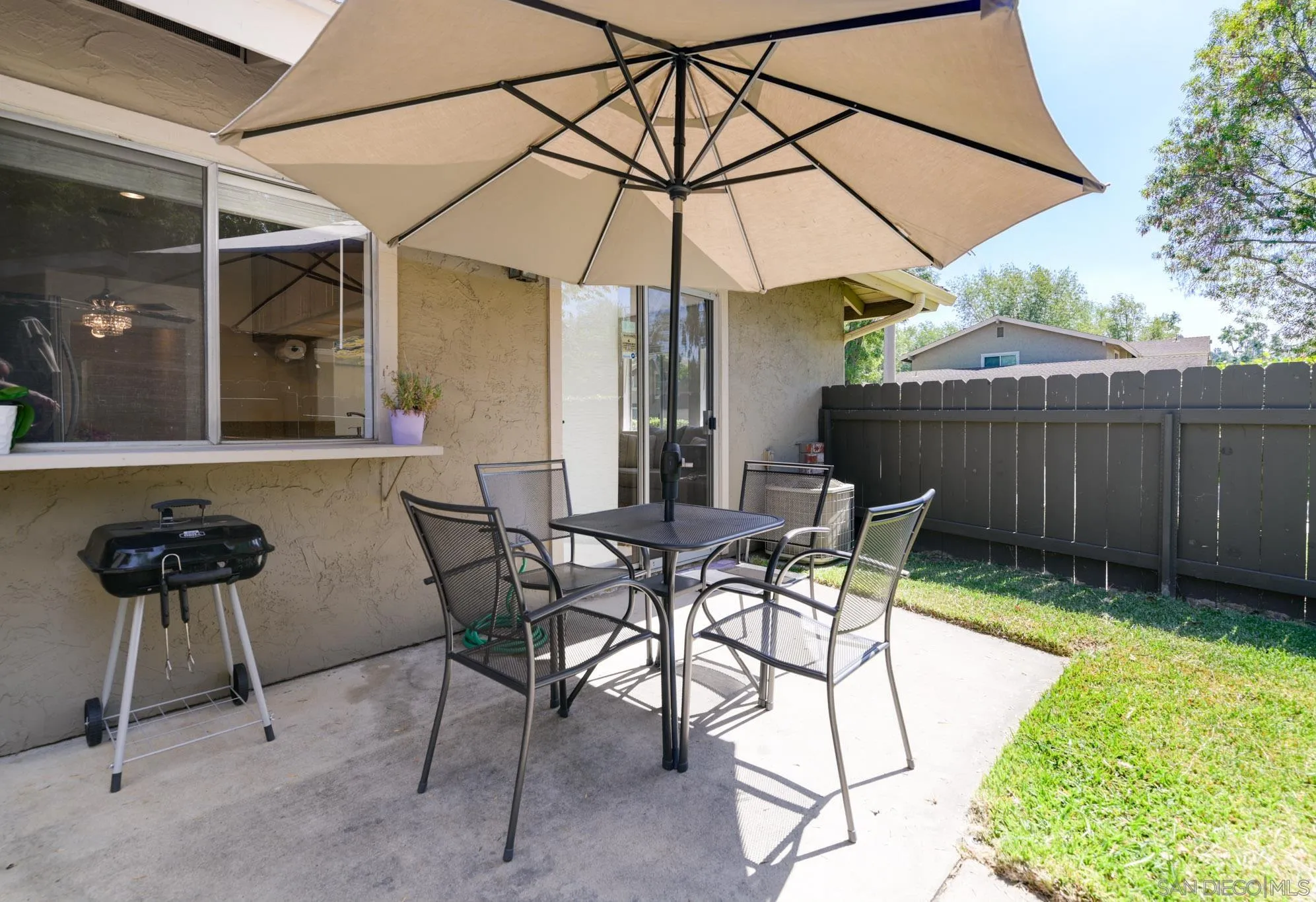 1536 Gustavo Street, Unit A El Cajon, CA 92019 - Photo 23 of 28 a patio with a table and chairs under an umbrella