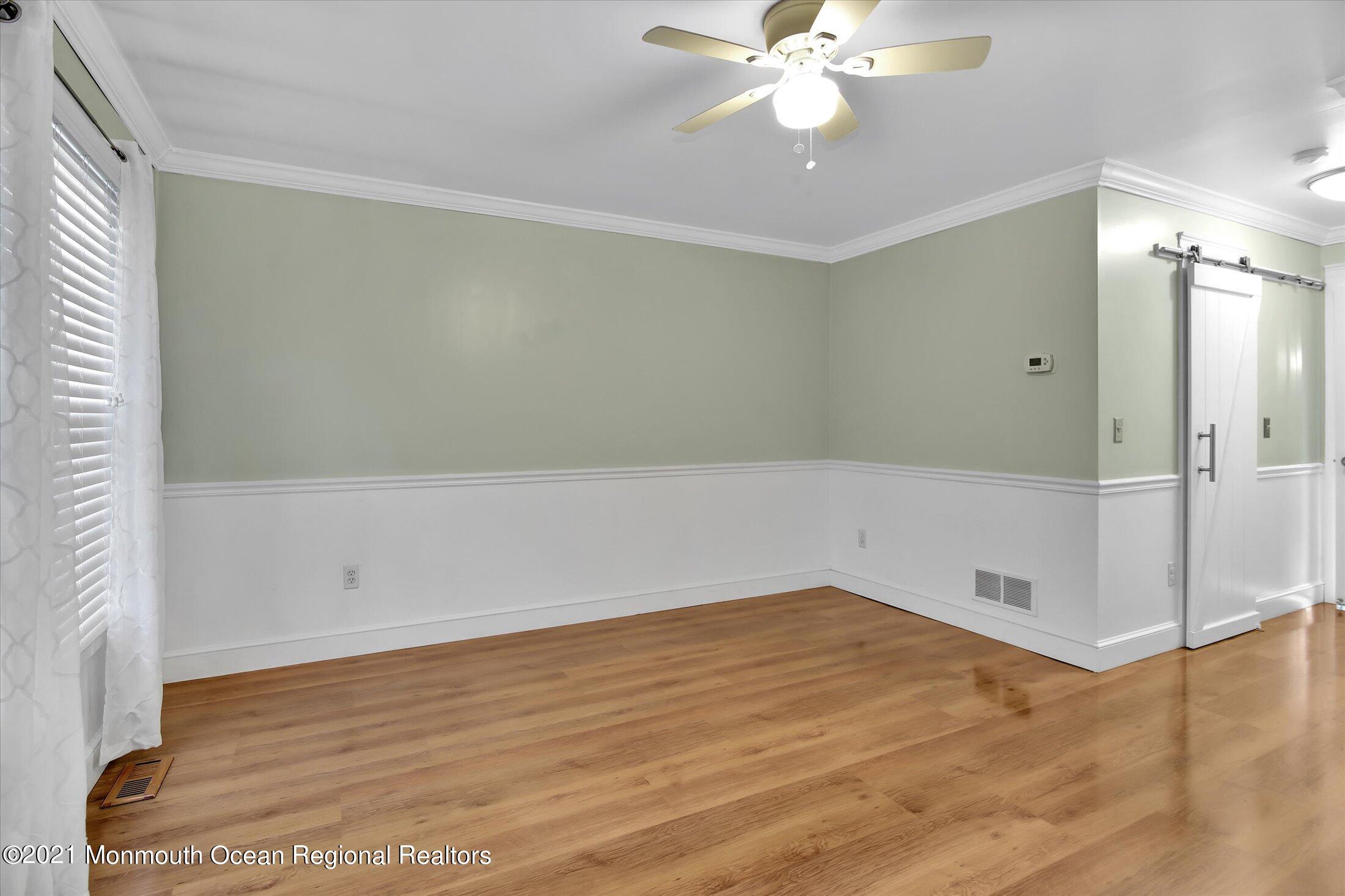 204 Schooner Road Manahawkin, NJ 08050 - Photo 14 of 34 a view of empty room with wooden floor and fan