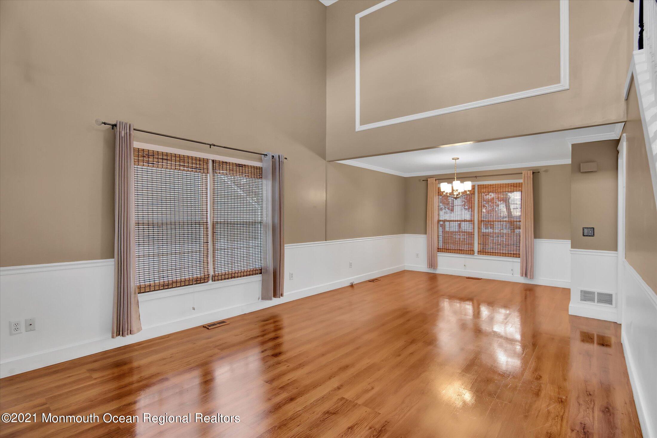 204 Schooner Road Manahawkin, NJ 08050 - Photo 4 of 34 a view of an empty room with wooden floor and a window