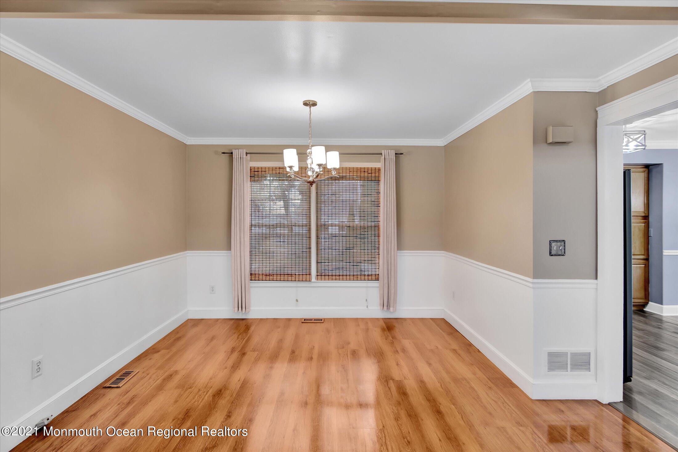 204 Schooner Road Manahawkin, NJ 08050 - Photo 7 of 34 a view of an empty room with wooden floor and a window
